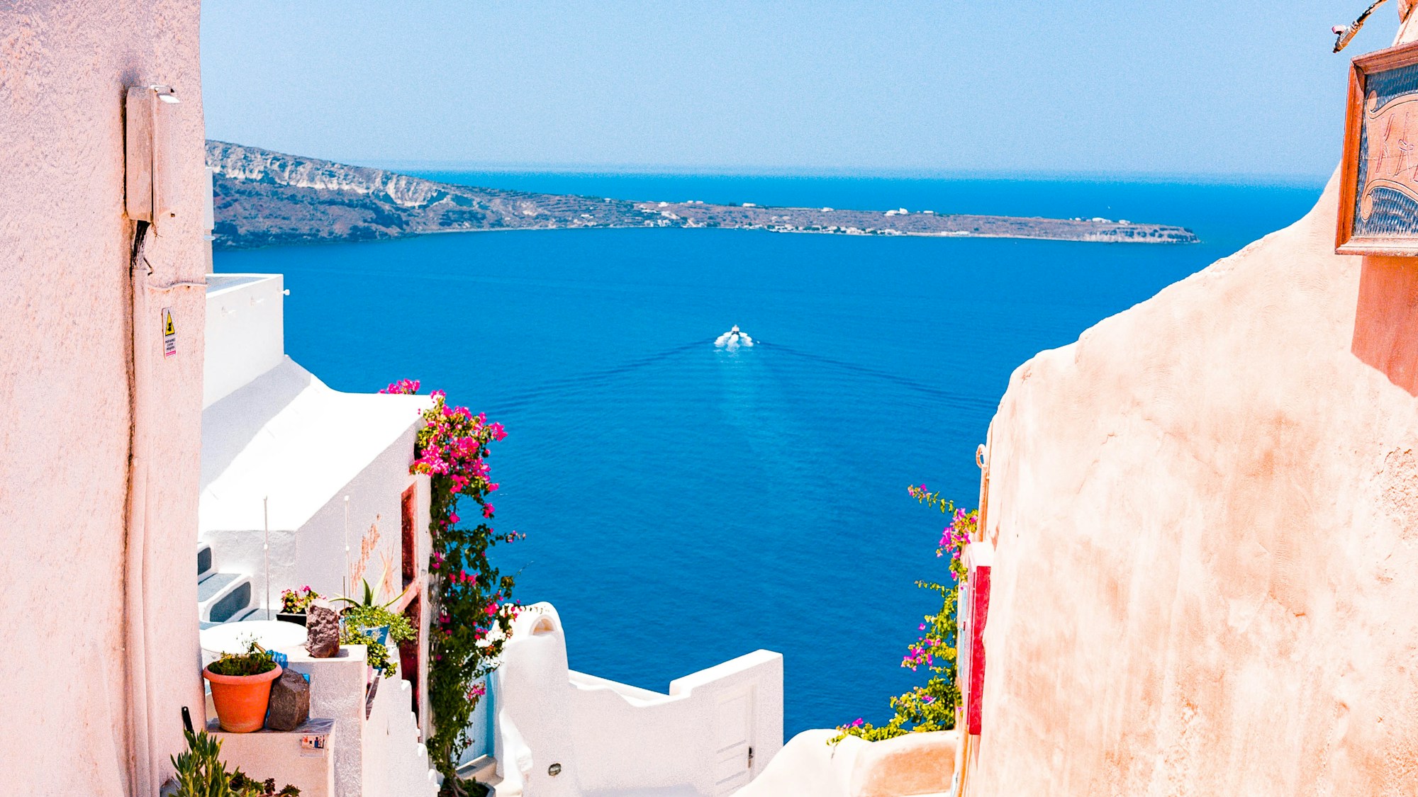Santorini whitewashed houses with blue domes and Aegean Sea — Greece monthly budget guide