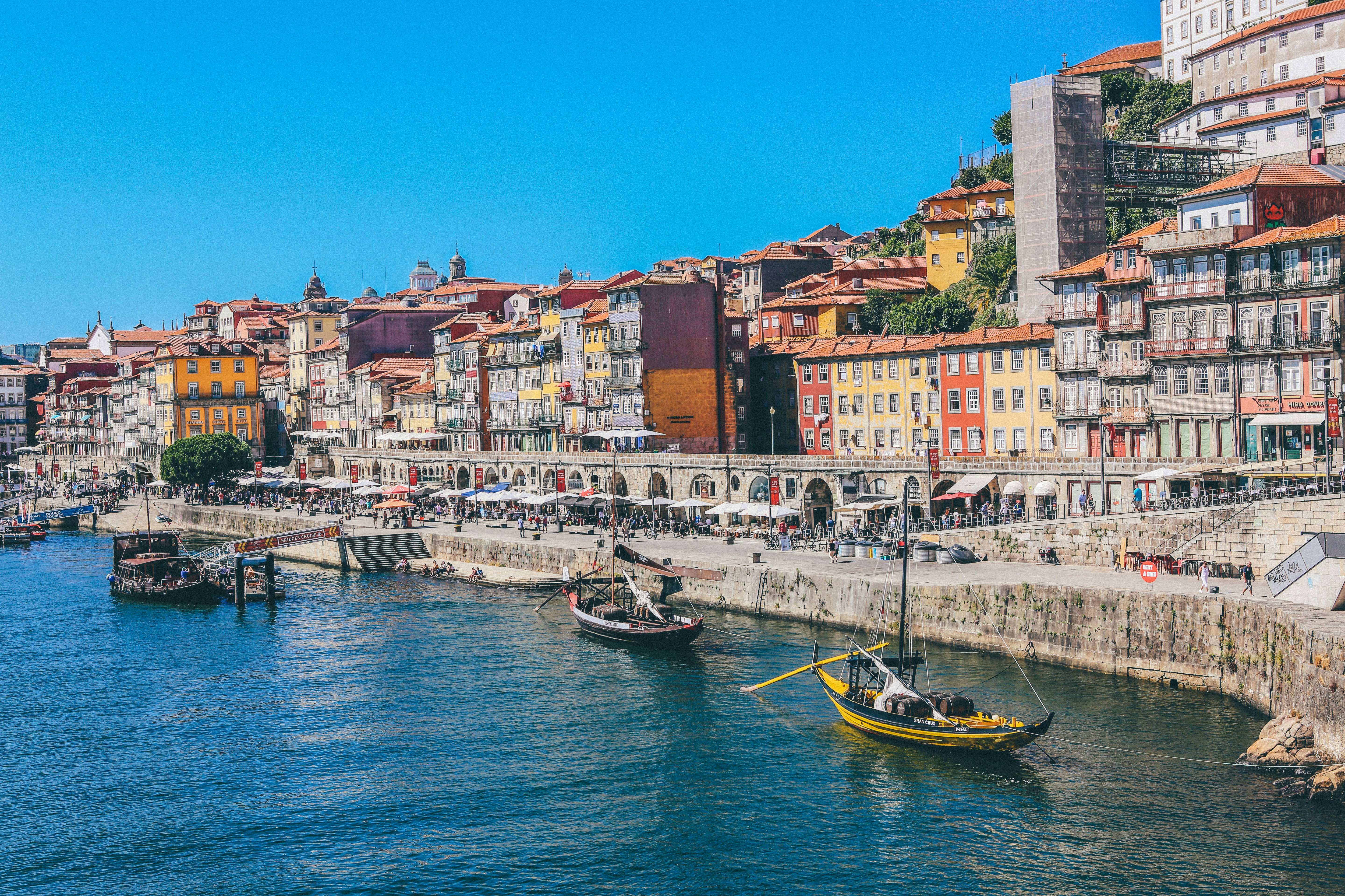 Lisbon rooftops, yellow trams and Tagus River at golden hour — Portugal cost of living guide